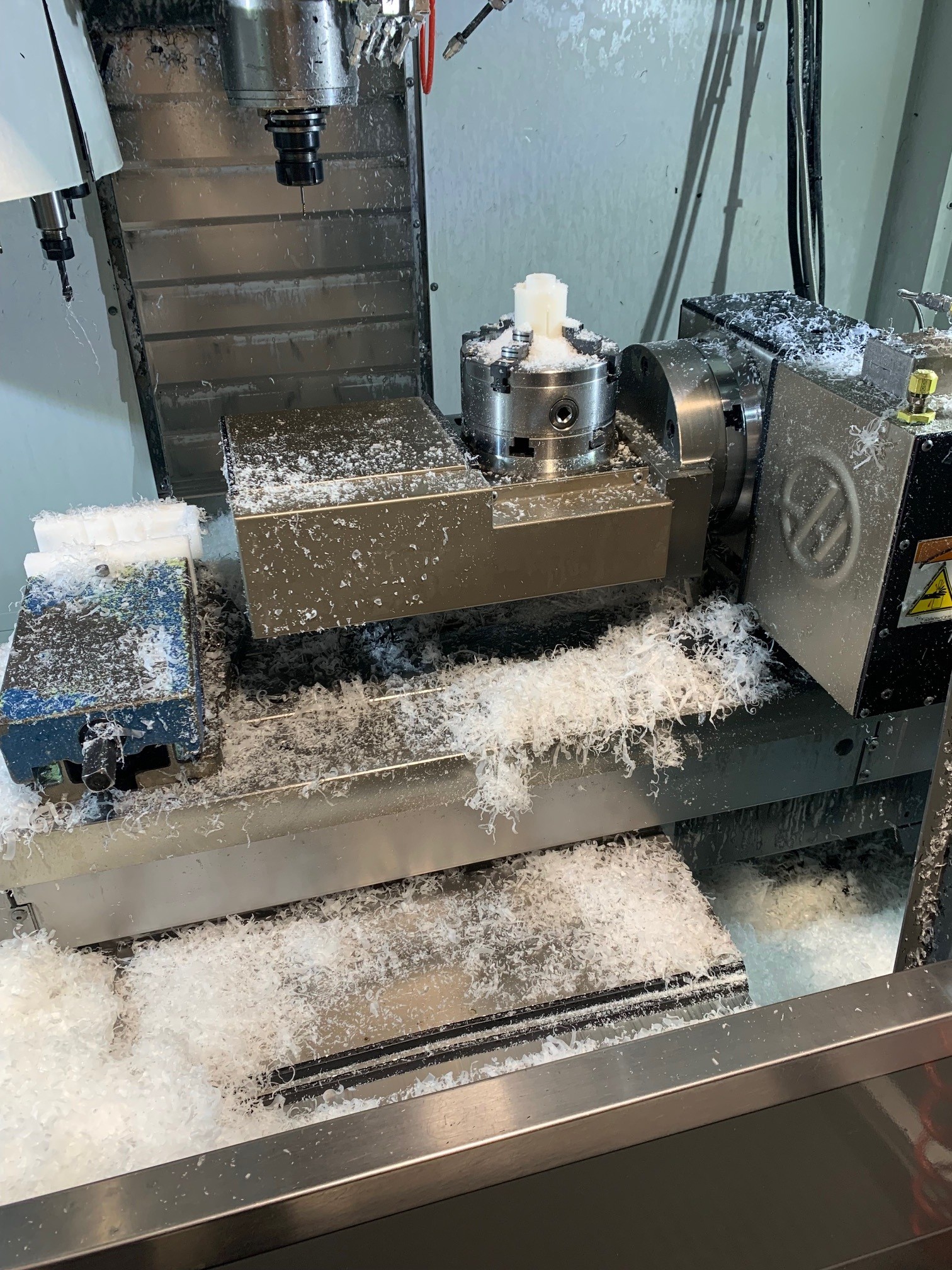 Weiße Spähne kommen aus Maschine.